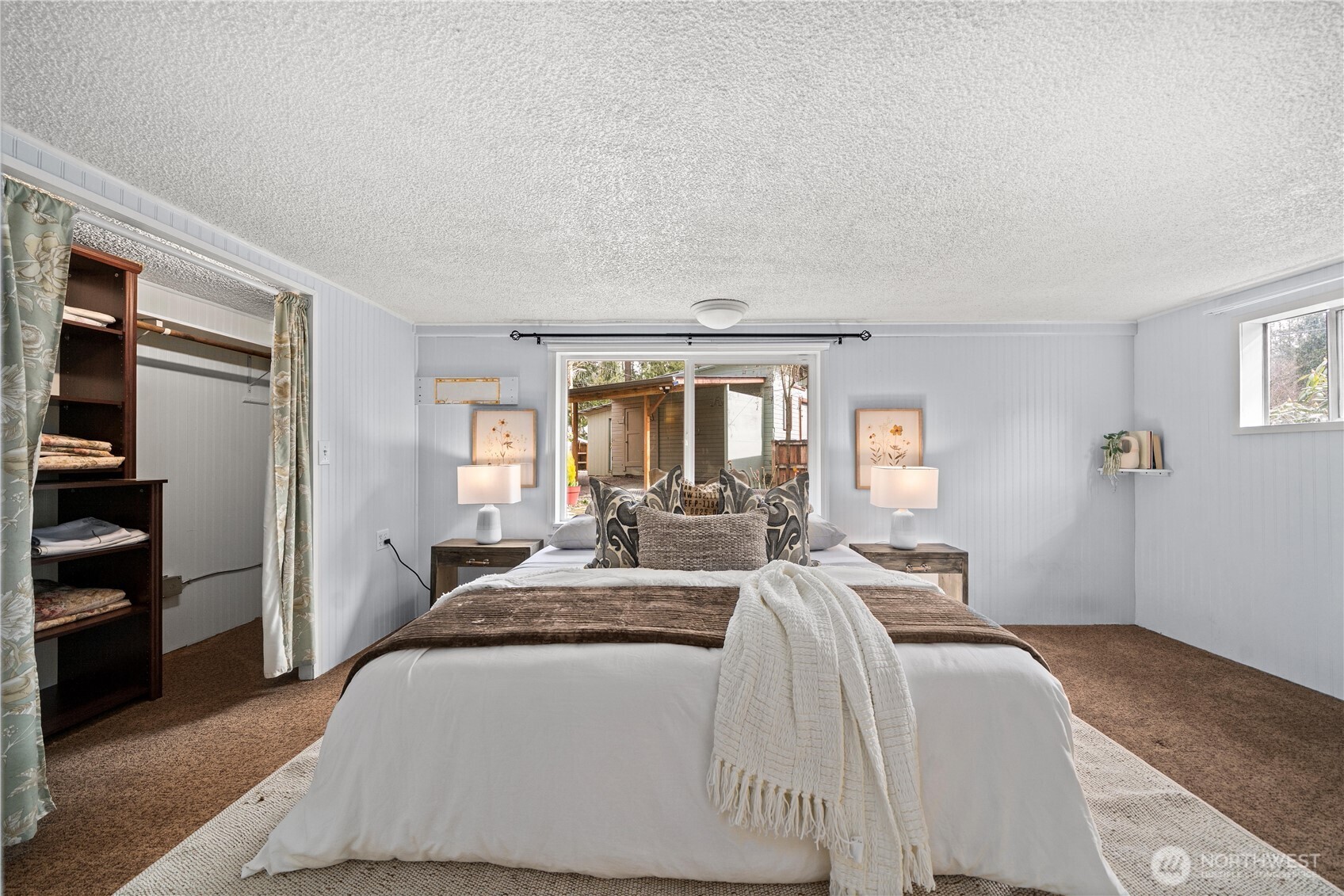 23711 Dorre Don Way Southeast Maple Valley, WA 98038 - Photo 22 of 40 a spacious bedroom with a bed and wooden floor