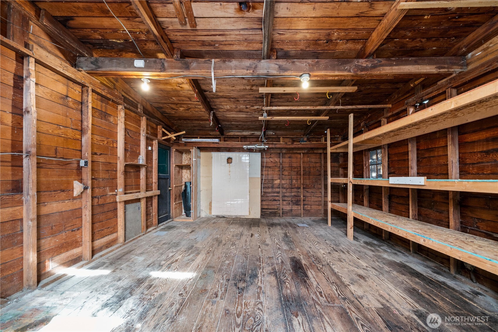 23711 Dorre Don Way Southeast Maple Valley, WA 98038 - Photo 34 of 40 a view of an empty room with wooden floor and a window