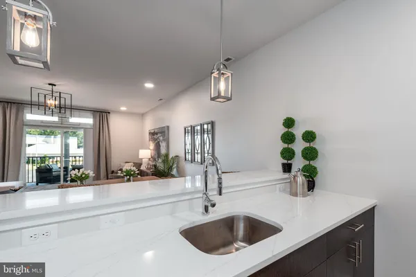 a kitchen with stainless steel appliances granite countertop a sink a stove top oven a refrigerator and dishwasher