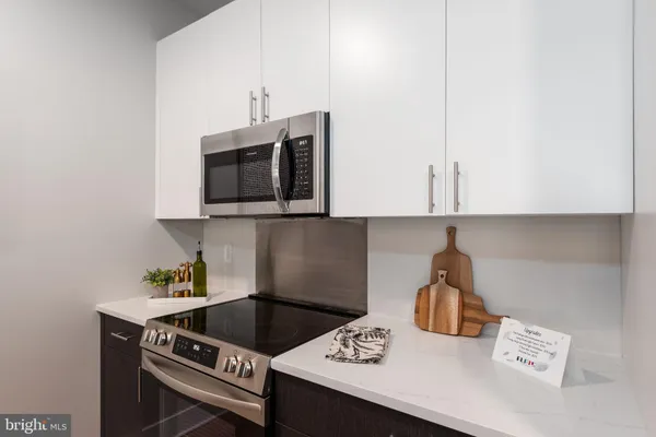 a view of a kitchen counter top space a sink and living room view