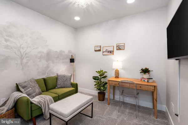 a bedroom with a bed and a potted plant