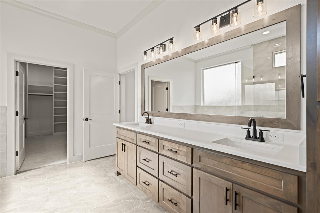 115 Red Bud Road Boyd, TX 76023 - Photo 25 of 38 Spacious bathroom featuring a dual vanity with light wood-finish cabinetry, white countertops, and matte black fixtures