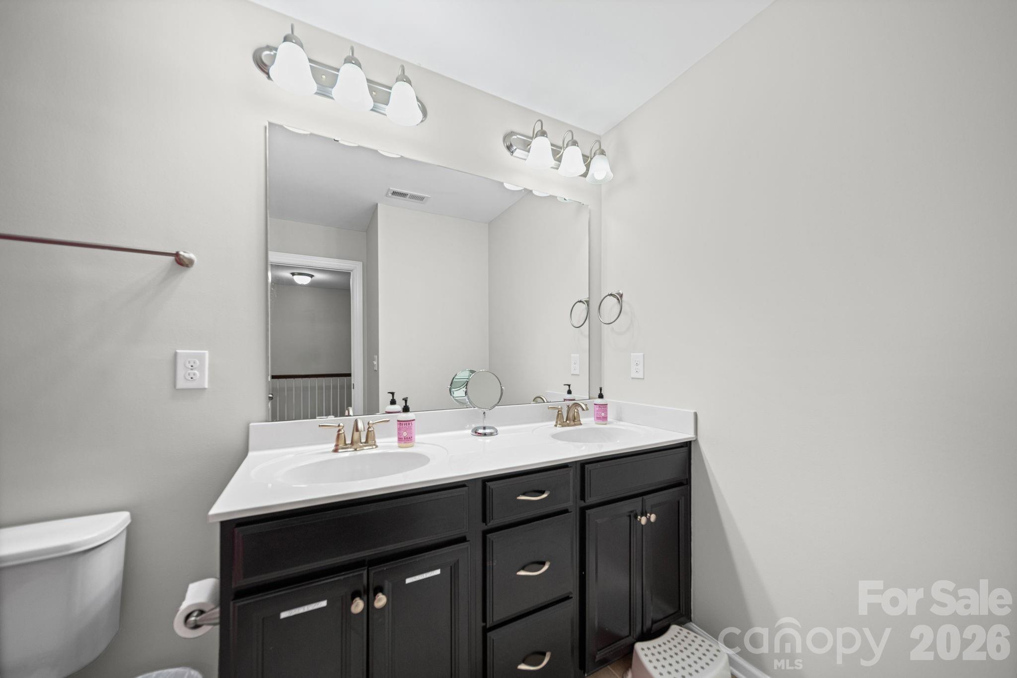 1108 Roderick Drive Fort Mill, SC 29708 - Photo 26 of 39 a bathroom with a sink vanity and a mirror