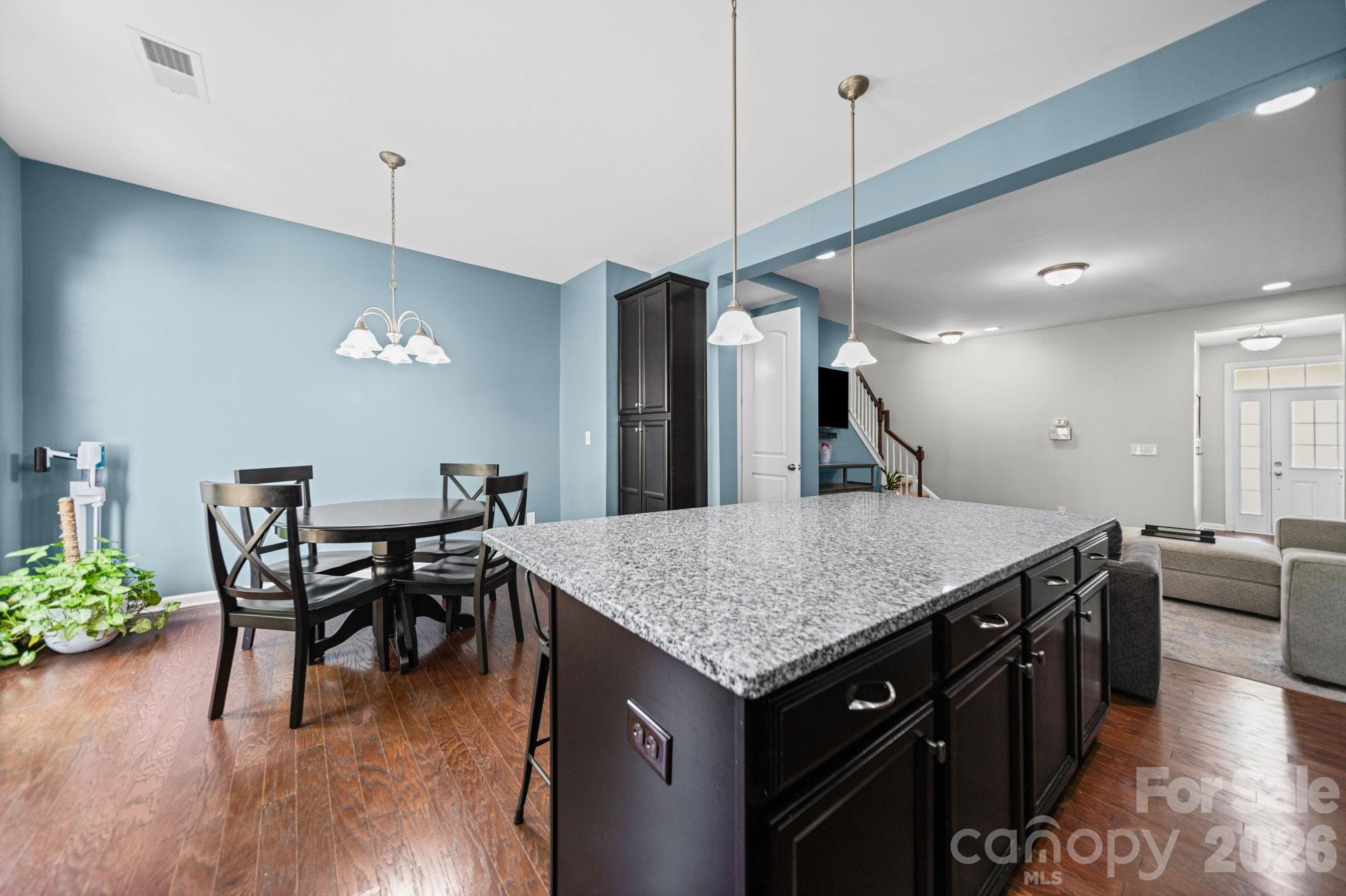 1108 Roderick Drive Fort Mill, SC 29708 - Photo 9 of 39 a kitchen with stainless steel appliances granite countertop dining table chairs and wooden floor