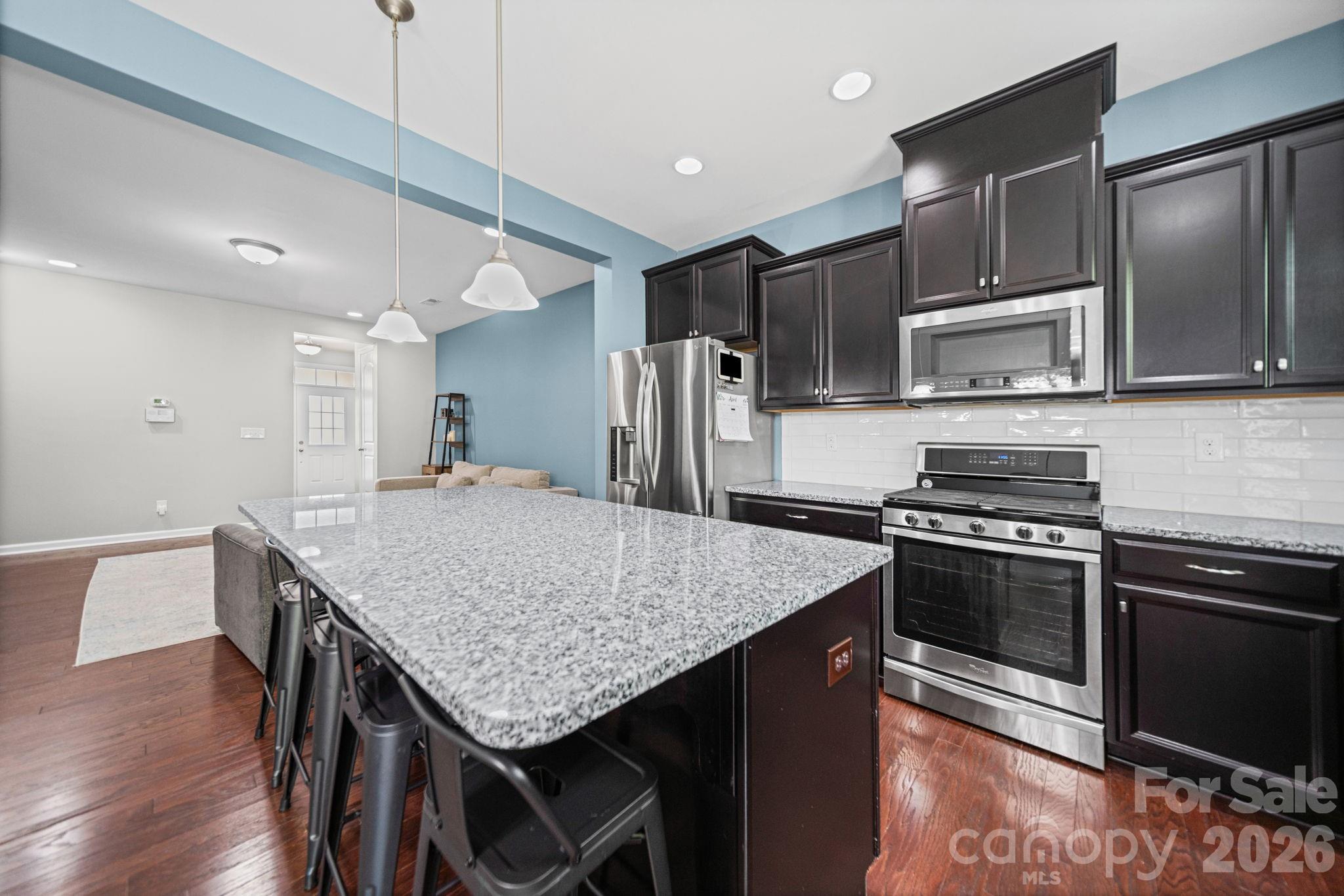 1108 Roderick Drive Fort Mill, SC 29708 - Photo 10 of 39 a kitchen with stainless steel appliances granite countertop a stove a refrigerator and a microwave