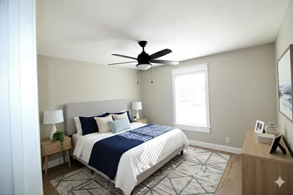a bedroom with a bed and a ceiling fan