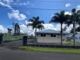 18-7856 Kaniela Road Mountain View, HI 96771 - Photo 2 of 30 a front view of a house with a garden and tree
