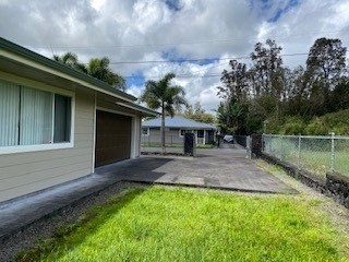 18-7856 Kaniela Road Mountain View, HI 96771 - Photo 26 of 30 a front view of a house with a yard
