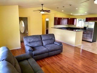18-7856 Kaniela Road Mountain View, HI 96771 - Photo 7 of 30 a living room with stainless steel appliances furniture and a wooden floor