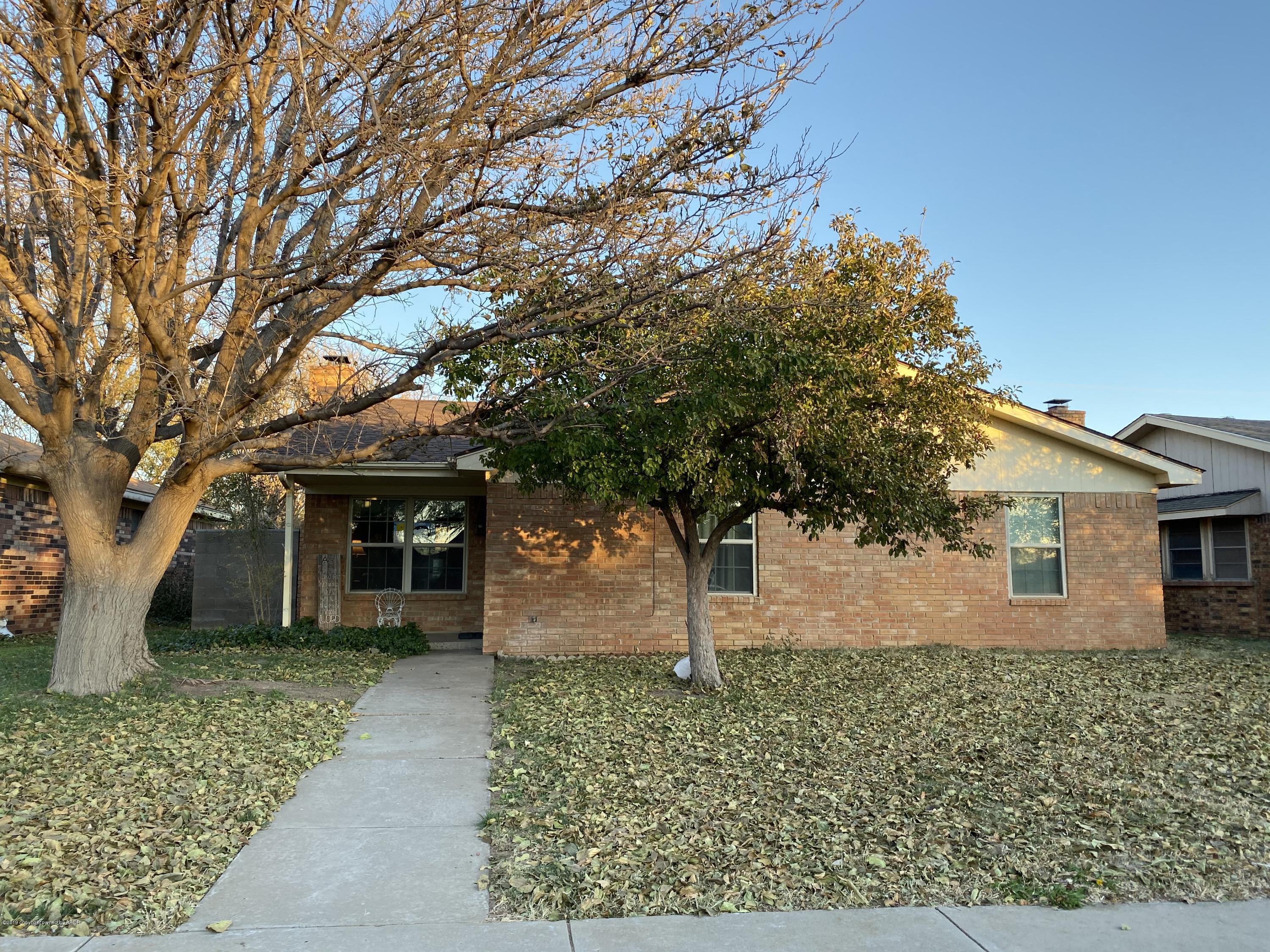front view of a house with a tree