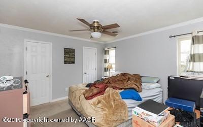 5211 South Milam Street Amarillo, TX 79110 - Photo 23 of 31 a bedroom with a bed and a window
