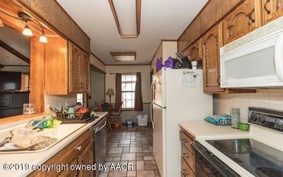 5211 South Milam Street Amarillo, TX 79110 - Photo 8 of 31 a kitchen with a refrigerator a sink and a stove