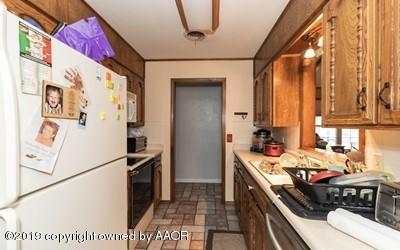 5211 South Milam Street Amarillo, TX 79110 - Photo 10 of 31 a kitchen with a refrigerator and a stove