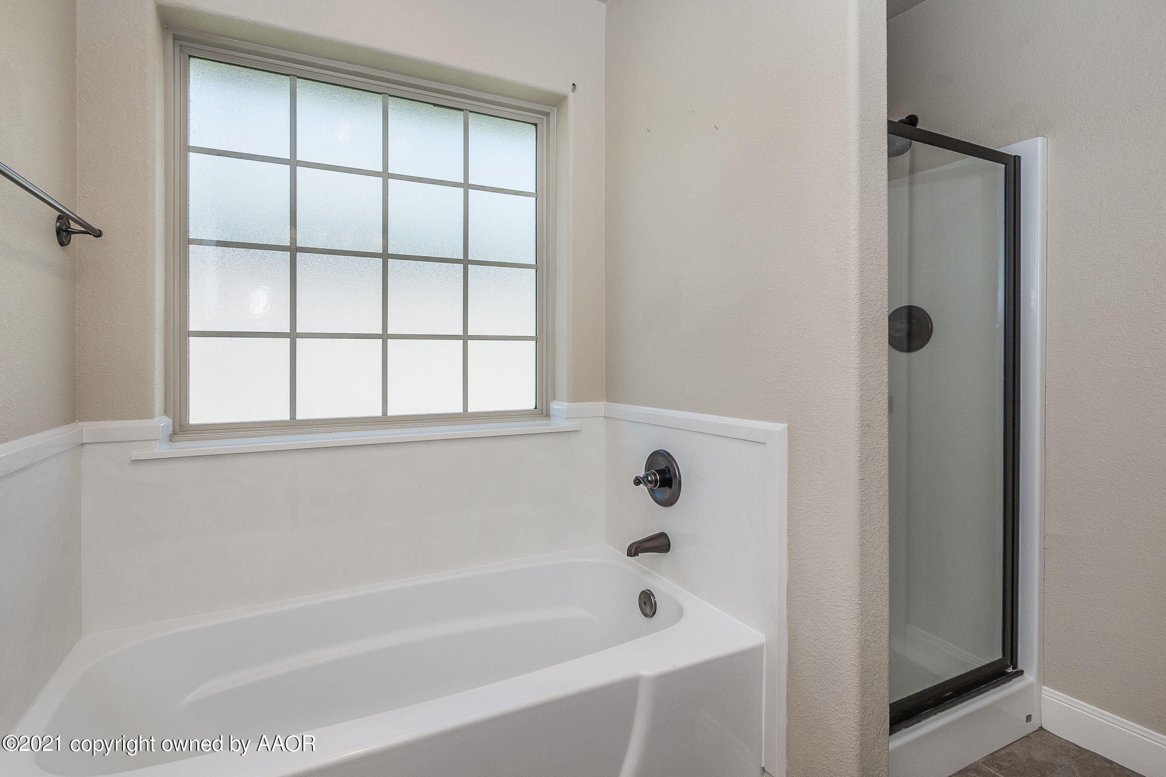 3908 Arden Road Amarillo, TX 79118 - Photo 13 of 25 a bathroom with a bathtub and next to a window