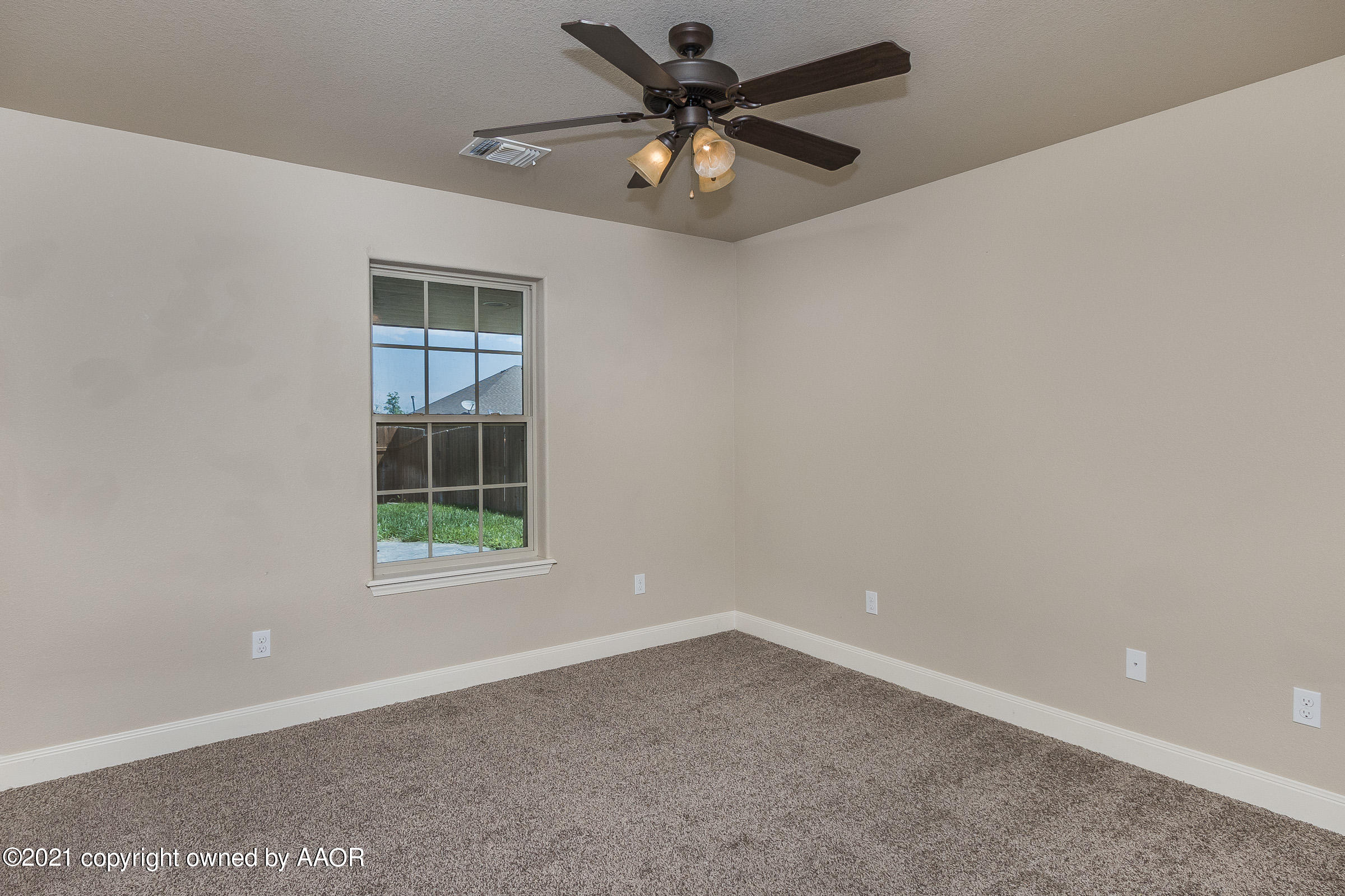 3908 Arden Road Amarillo, TX 79118 - Photo 15 of 25 an empty room with a window and a fan