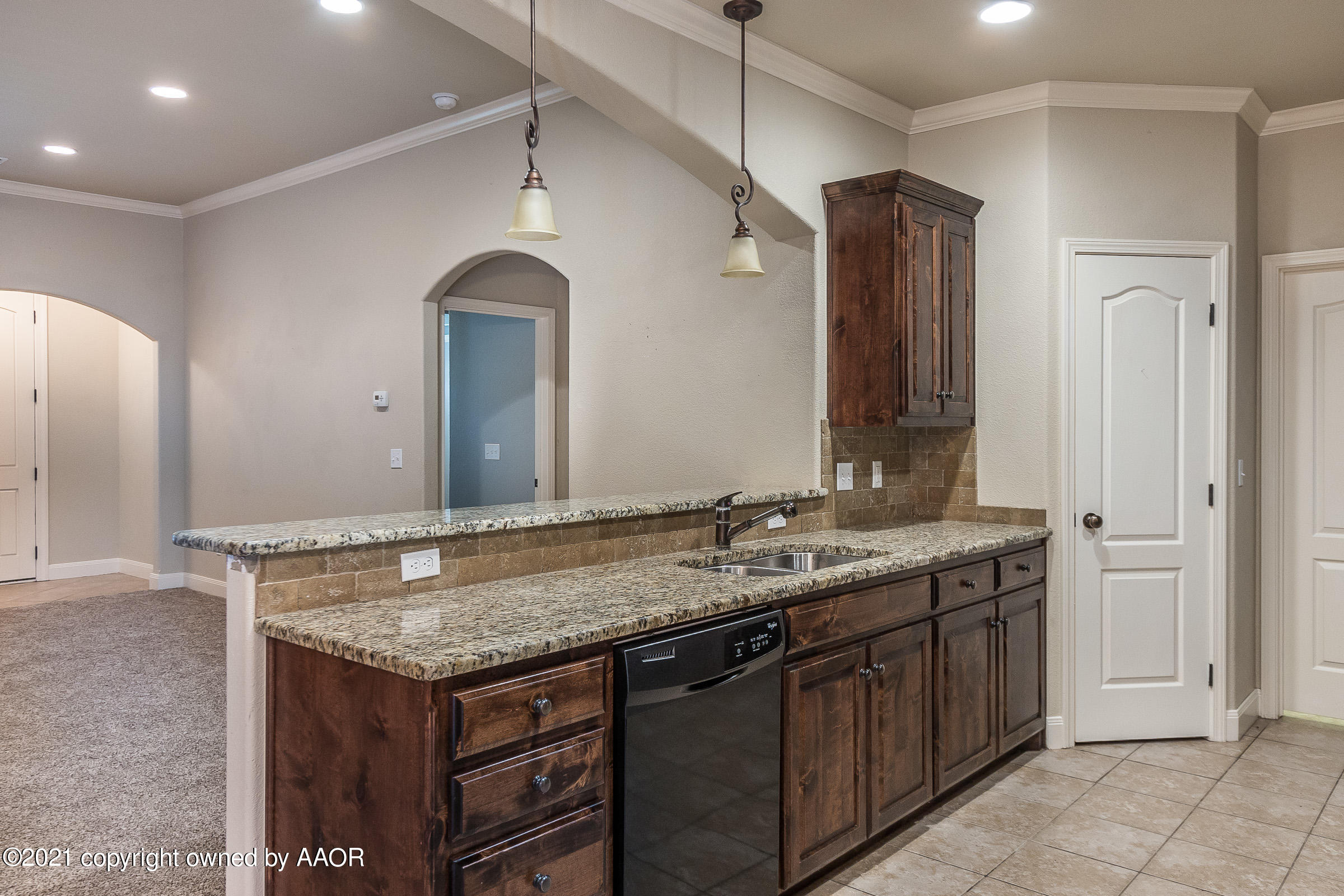 3908 Arden Road Amarillo, TX 79118 - Photo 8 of 25 a bathroom with a granite countertop sink a large mirror and a wooden cabinets