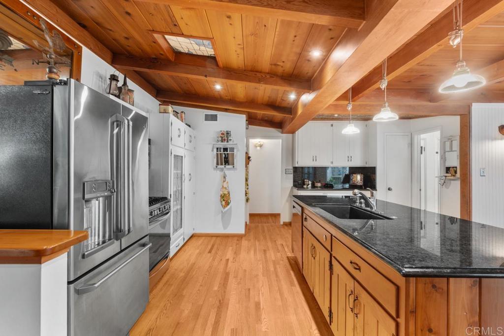 220 Hoover Street Oceanside, CA 92054 - Photo 14 of 70 a kitchen with stainless steel appliances granite countertop a sink a stove and a refrigerator