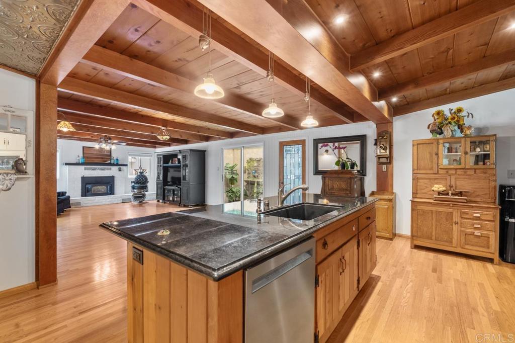 220 Hoover Street Oceanside, CA 92054 - Photo 16 of 70 a kitchen with stainless steel appliances granite countertop a sink and wooden cabinets