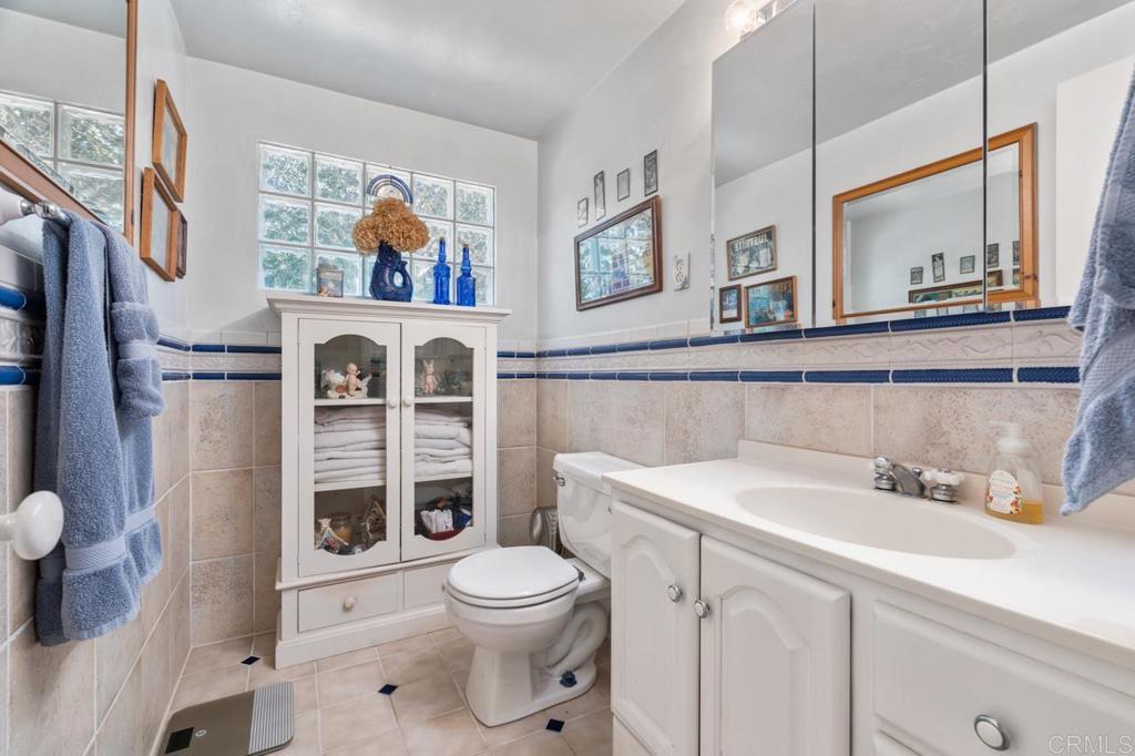 220 Hoover Street Oceanside, CA 92054 - Photo 22 of 70 a bathroom with a toilet a sink and a mirror