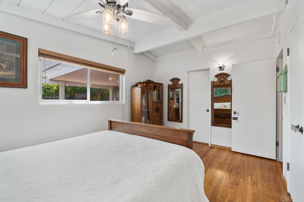 220 Hoover Street Oceanside, CA 92054 - Photo 23 of 70 a bedroom with a large bed and a chandelier