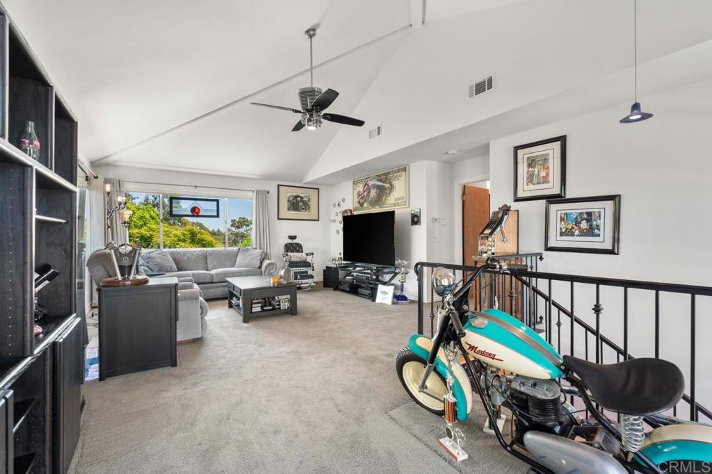 220 Hoover Street Oceanside, CA 92054 - Photo 29 of 70 a living room with furniture gym equipment and a flat screen tv