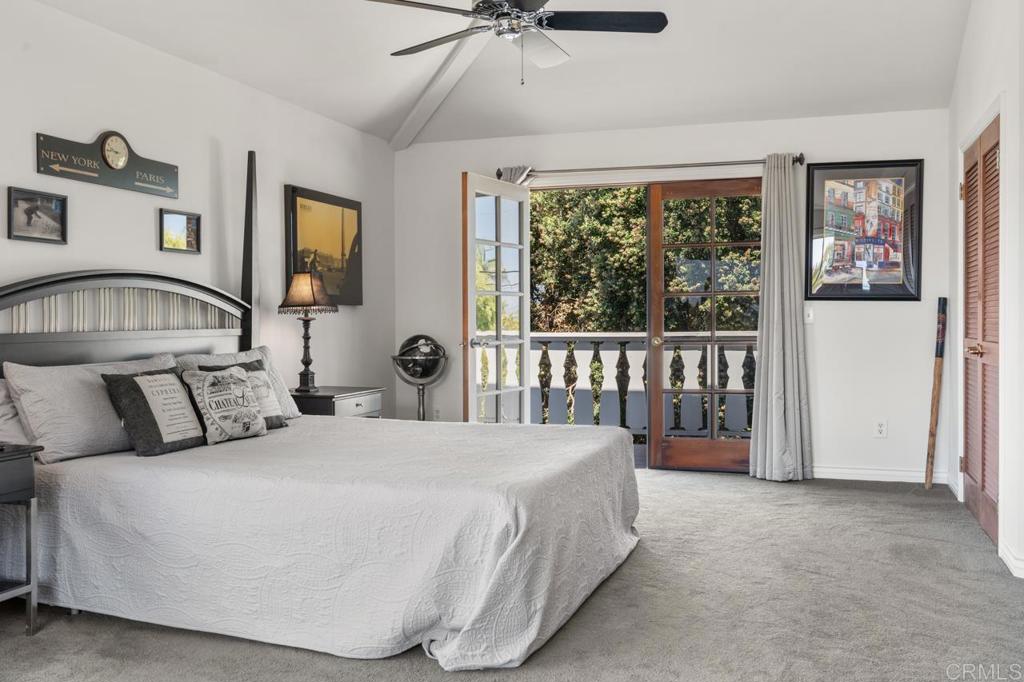 220 Hoover Street Oceanside, CA 92054 - Photo 32 of 70 a bedroom with a balcony a bed and a window
