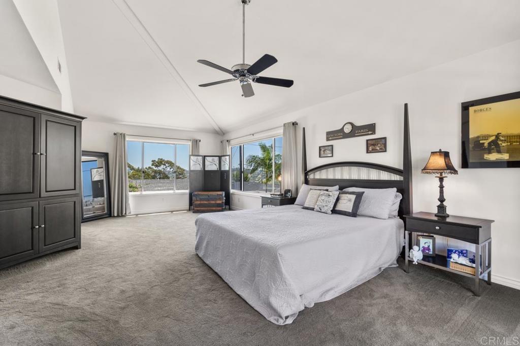 220 Hoover Street Oceanside, CA 92054 - Photo 33 of 70 a spacious bedroom with a bed a dresser and a chandelier