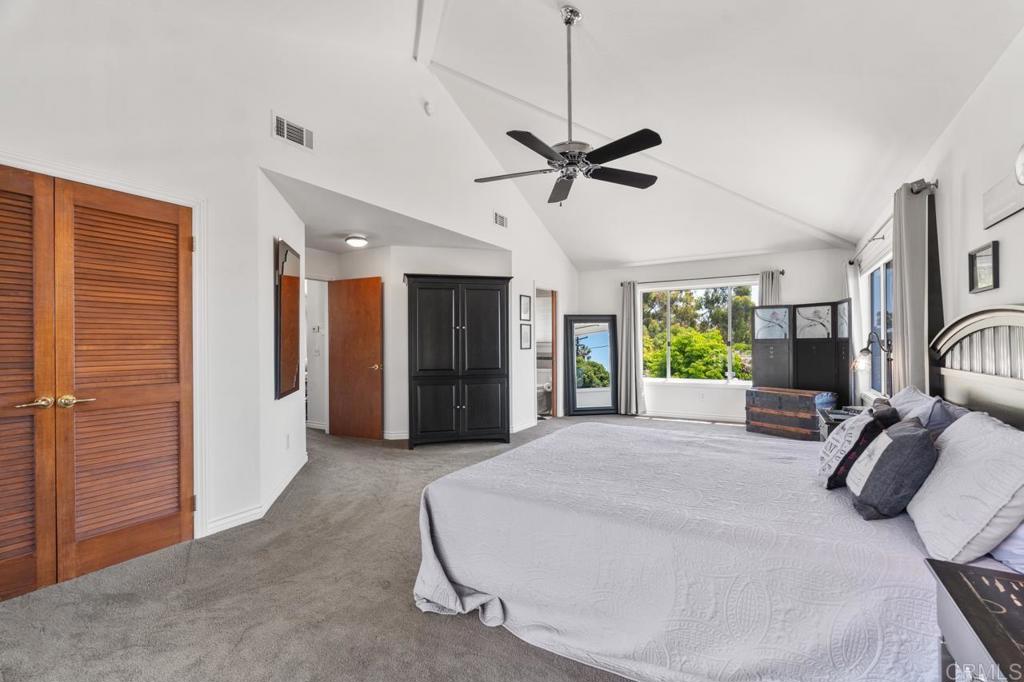 220 Hoover Street Oceanside, CA 92054 - Photo 34 of 70 a spacious bedroom with a bed a ceiling fan and a rug