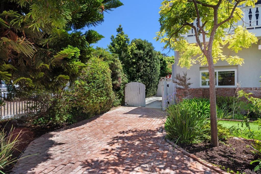 220 Hoover Street Oceanside, CA 92054 - Photo 4 of 70 a front view of a house with a yard and a tree