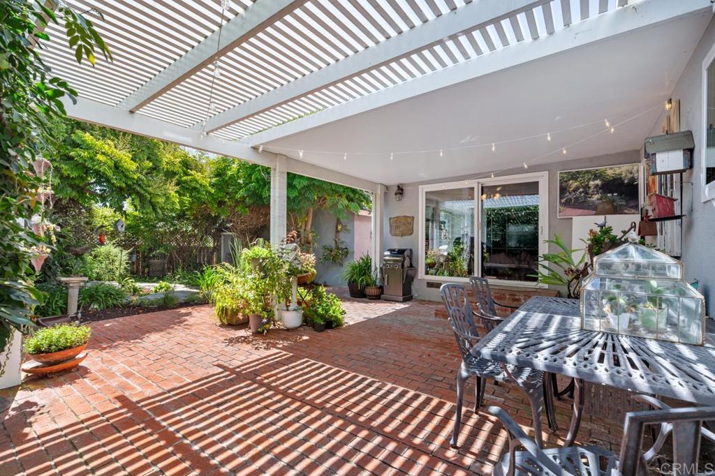220 Hoover Street Oceanside, CA 92054 - Photo 42 of 70 a view of a patio with table and chairs potted plants with wooden floor and fence