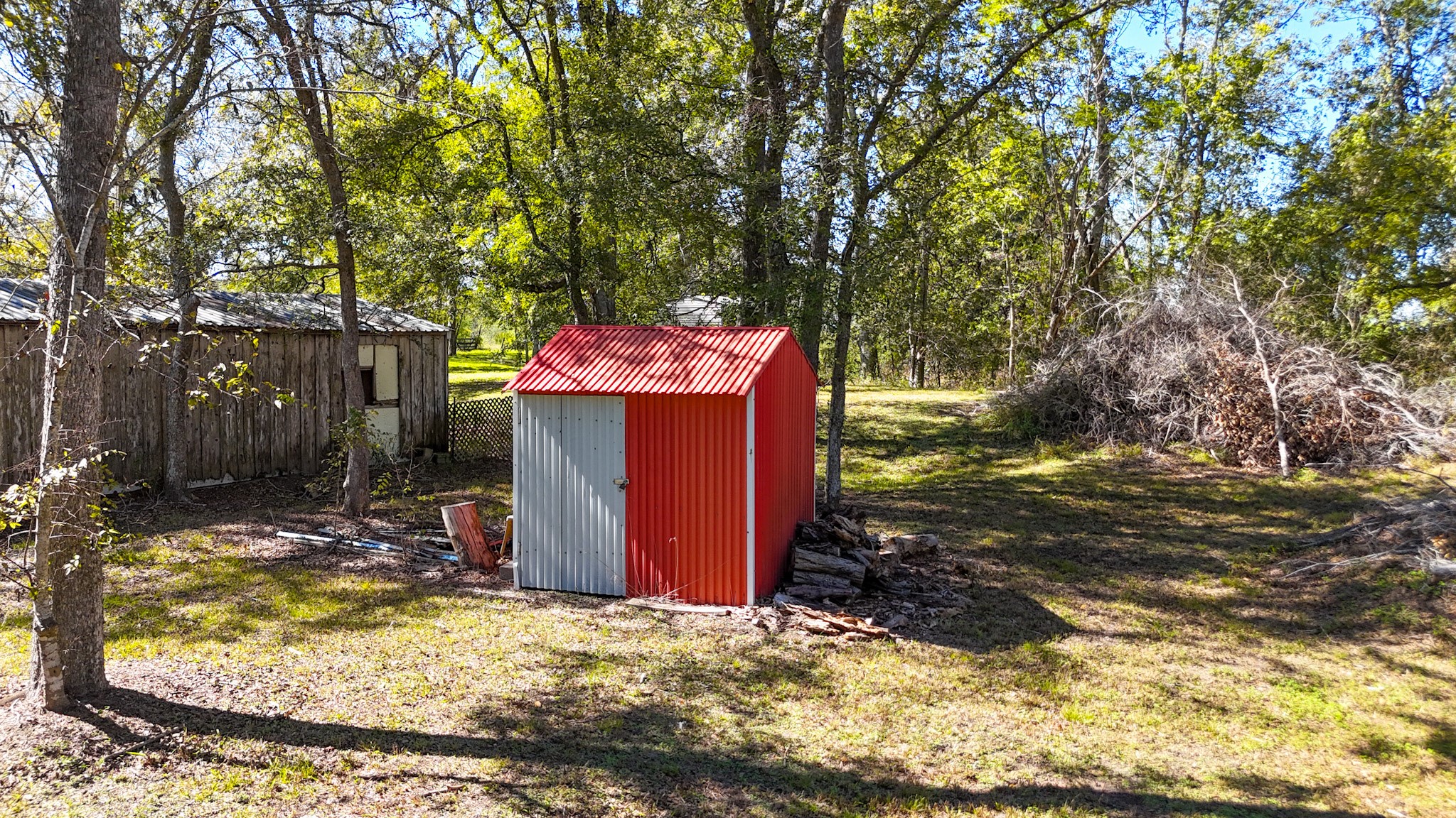 6253 North FM 441 Road El Campo, TX 77437 - Photo 7 of 7 a view of a wooden house with a yard