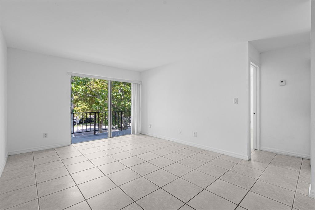 9225 Southwest 87th Avenue, Unit A7 Miami, FL 33176 - Photo 14 of 35 a view of an empty room with a window