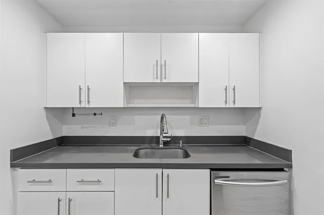 a kitchen with a sink cabinets and appliances
