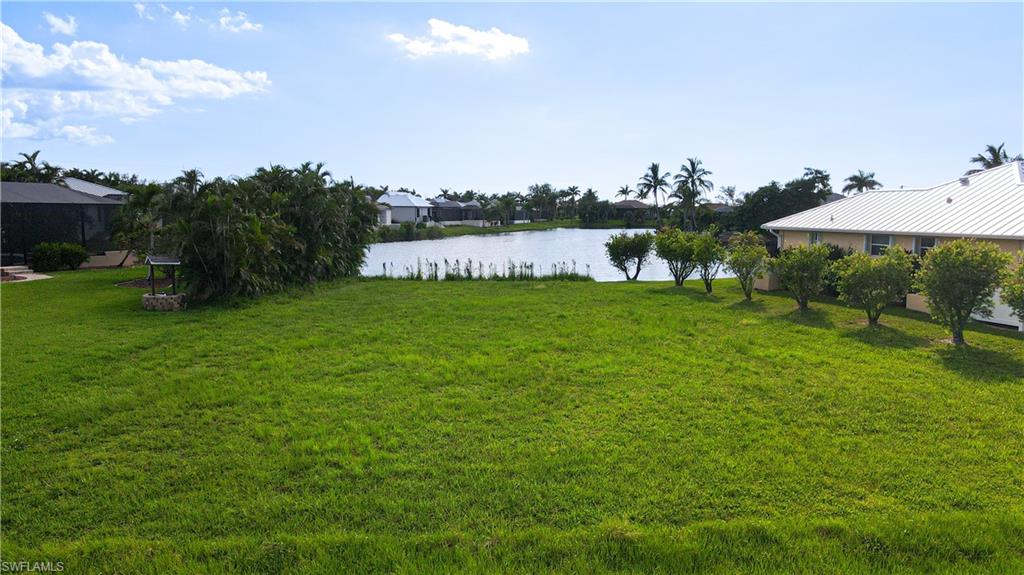 24083 Cedar Rapids Road Punta Gorda, FL 33955 - Photo 9 of 11 a view of a garden with a bench under an umbrella