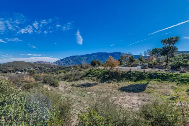 an aerial view of a residential houses with outdoor space