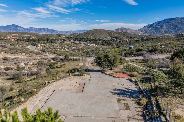 an aerial view of mountain with trees all around