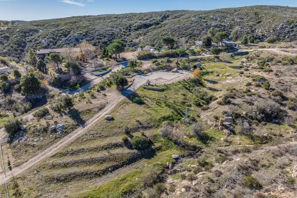an aerial view of a house with a mountain