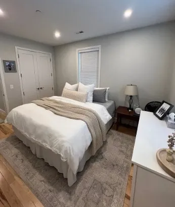 a bed room with a bed and a chair