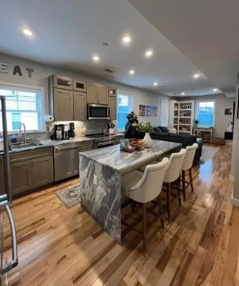 a kitchen with sink a microwave and cabinets