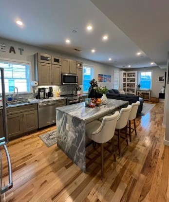 37 Kimball Street, Unit 2 Boston, MA 02122 - Photo 2 of 19 a kitchen with sink a microwave and cabinets