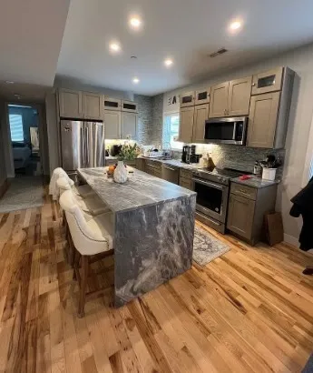 a large kitchen with sink cabinets and stainless steel appliances