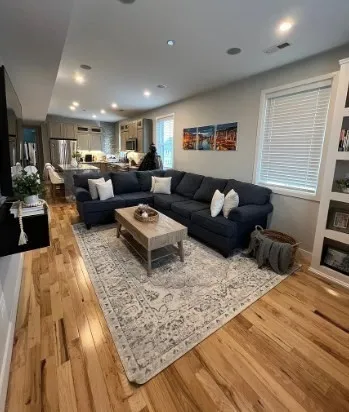 a living room with furniture and wooden floor