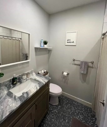 37 Kimball Street, Unit 2 Boston, MA 02122 - Photo 8 of 19 a bathroom with a granite countertop sink a toilet and a mirror