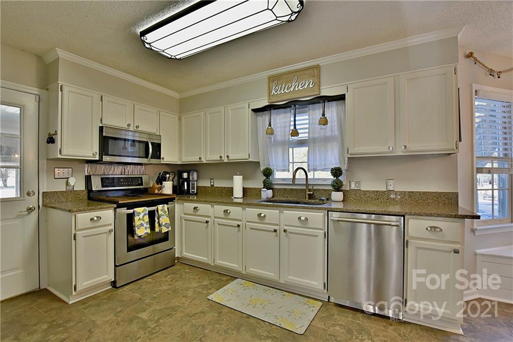 2984 Timber Ridge Lane Rock Hill, SC 29732 - Photo 11 of 32 a kitchen with stainless steel appliances granite countertop a stove a sink and a microwave