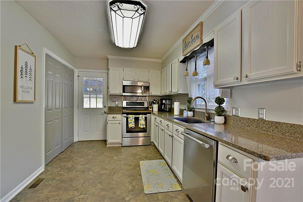 2984 Timber Ridge Lane Rock Hill, SC 29732 - Photo 12 of 32 a kitchen with stainless steel appliances granite countertop a stove sink and cabinets