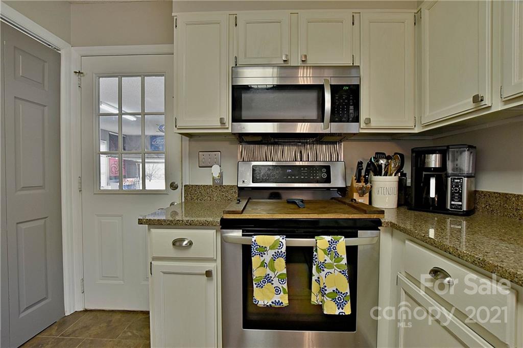 2984 Timber Ridge Lane Rock Hill, SC 29732 - Photo 14 of 32 a kitchen with stainless steel appliances granite countertop a stove and a white cabinets