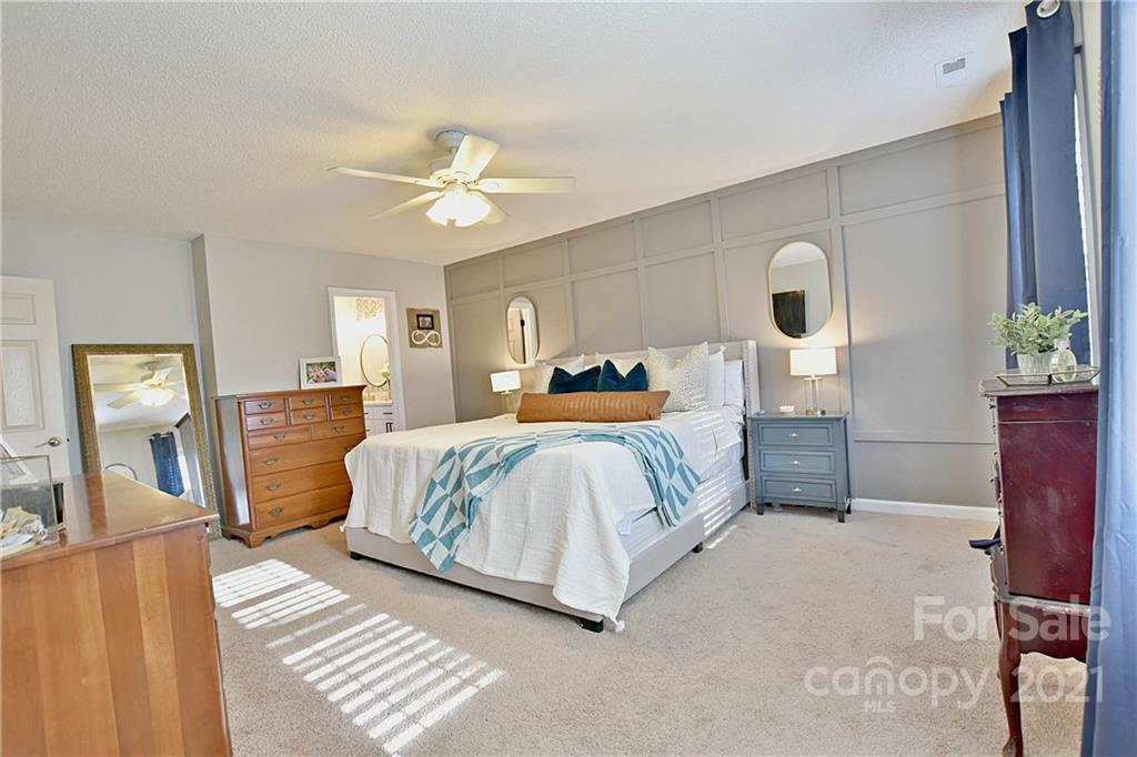 2984 Timber Ridge Lane Rock Hill, SC 29732 - Photo 19 of 32 a bedroom with a large bed chandelier and a window