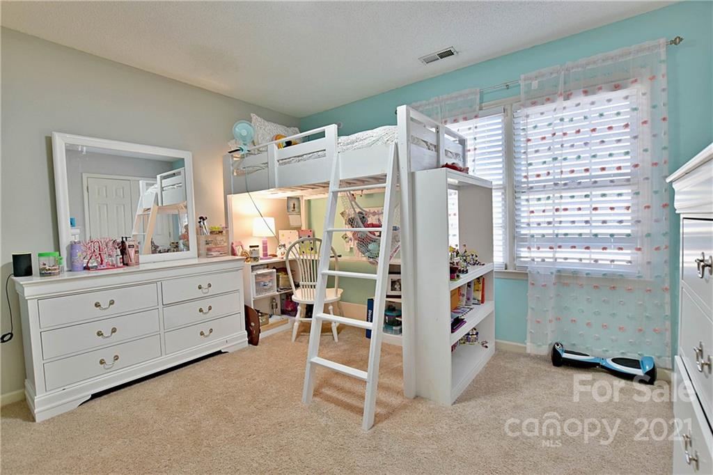 2984 Timber Ridge Lane Rock Hill, SC 29732 - Photo 22 of 32 a room with a bed and a mirror