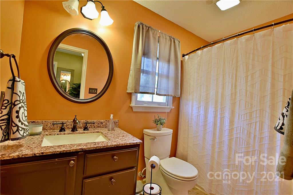 2984 Timber Ridge Lane Rock Hill, SC 29732 - Photo 24 of 32 a bathroom with a granite countertop toilet a sink and a mirror