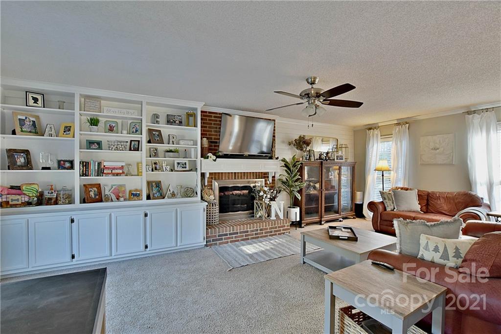 2984 Timber Ridge Lane Rock Hill, SC 29732 - Photo 6 of 32 a living room with furniture a fireplace and a ceiling fan
